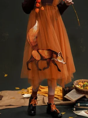 Burnt orange fox embroidered tulle strap midi skirt styled with mustard socks and lace-up leather shoes in an autumn vintage studio