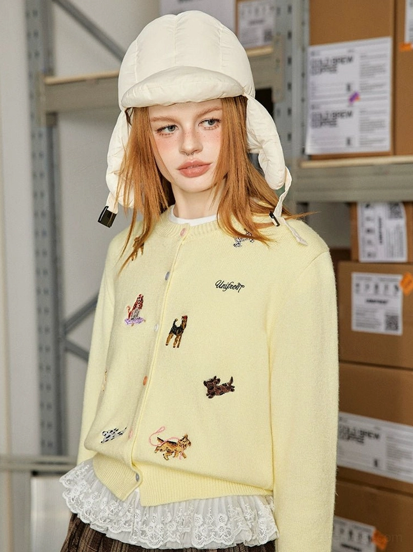 Butter yellow puppy embroidered knit cardigan with dog embroidery and lace trim styled with a puffer bucket hat