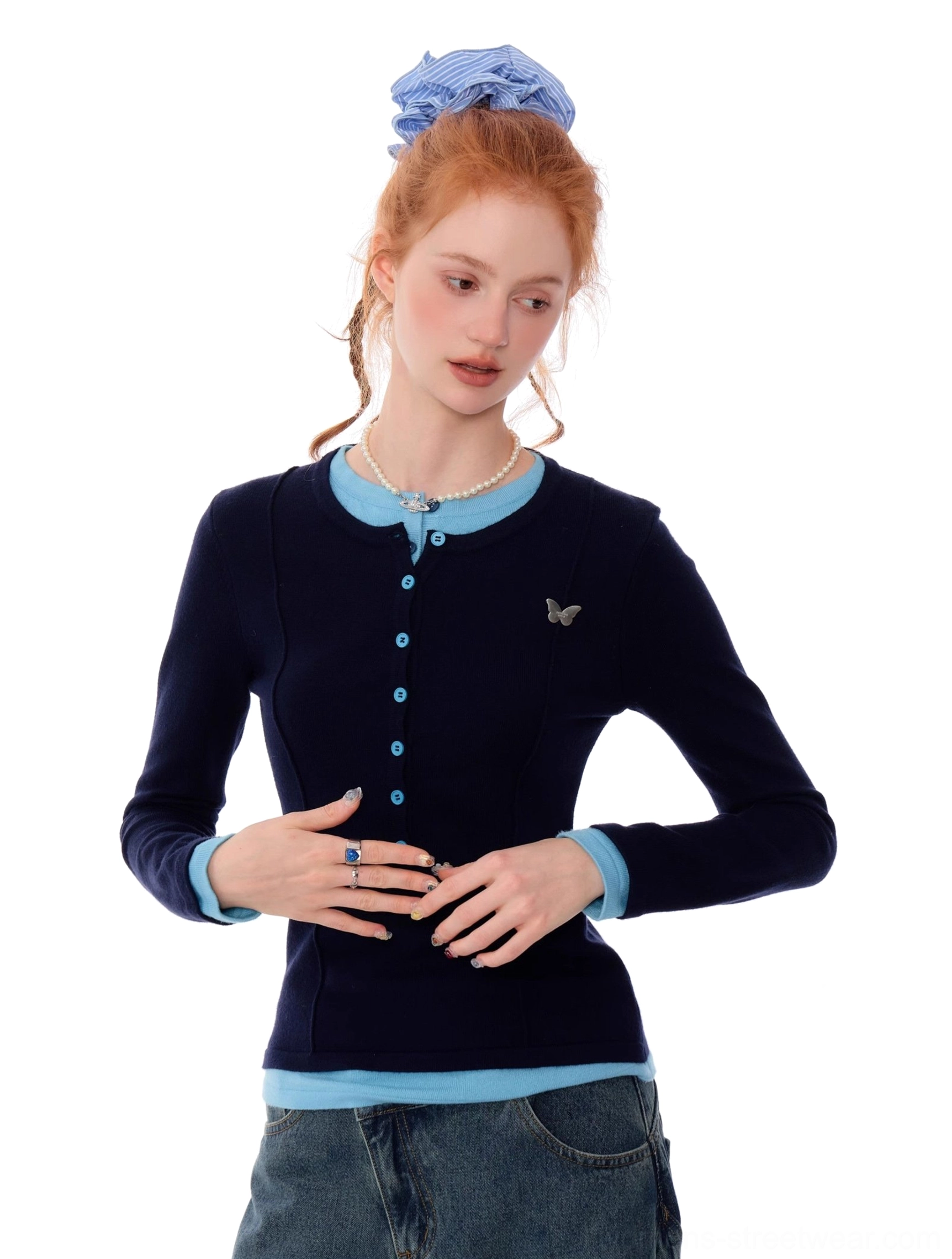 Close front portrait of fitted navy blue Henley knit top featuring light blue contrast trim and butterfly chest accent