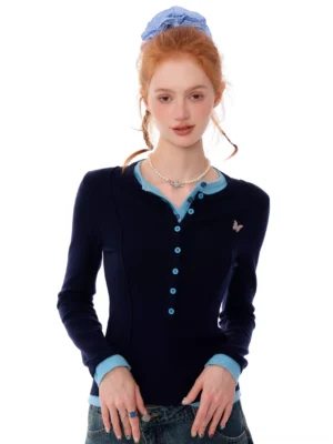 Navy blue butterfly contrast trim Henley knit top front view with light blue collar cuffs and hem