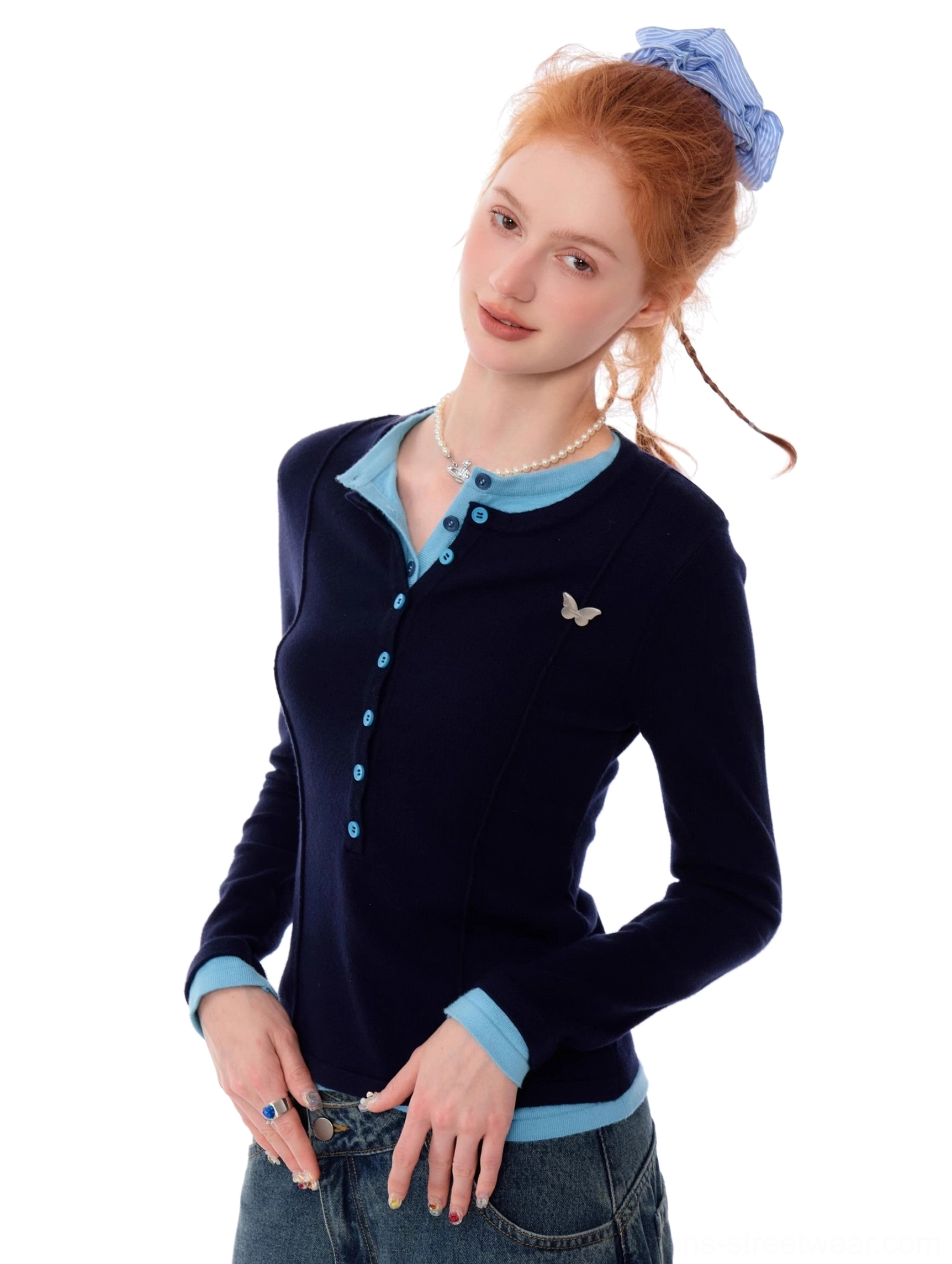 Women's navy blue slim fit Henley knit top with light blue contrast trim and butterfly chest detail side front view