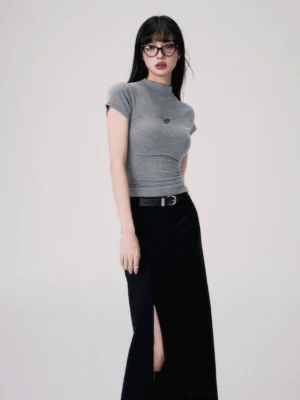 Heather gray butterfly embroidered fitted crop tee styled with a high slit black maxi skirt and leather belt