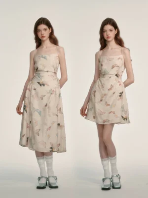 Front full-body view of a cream butterfly print spaghetti strap midi dress with square neckline and fitted waist on two female models