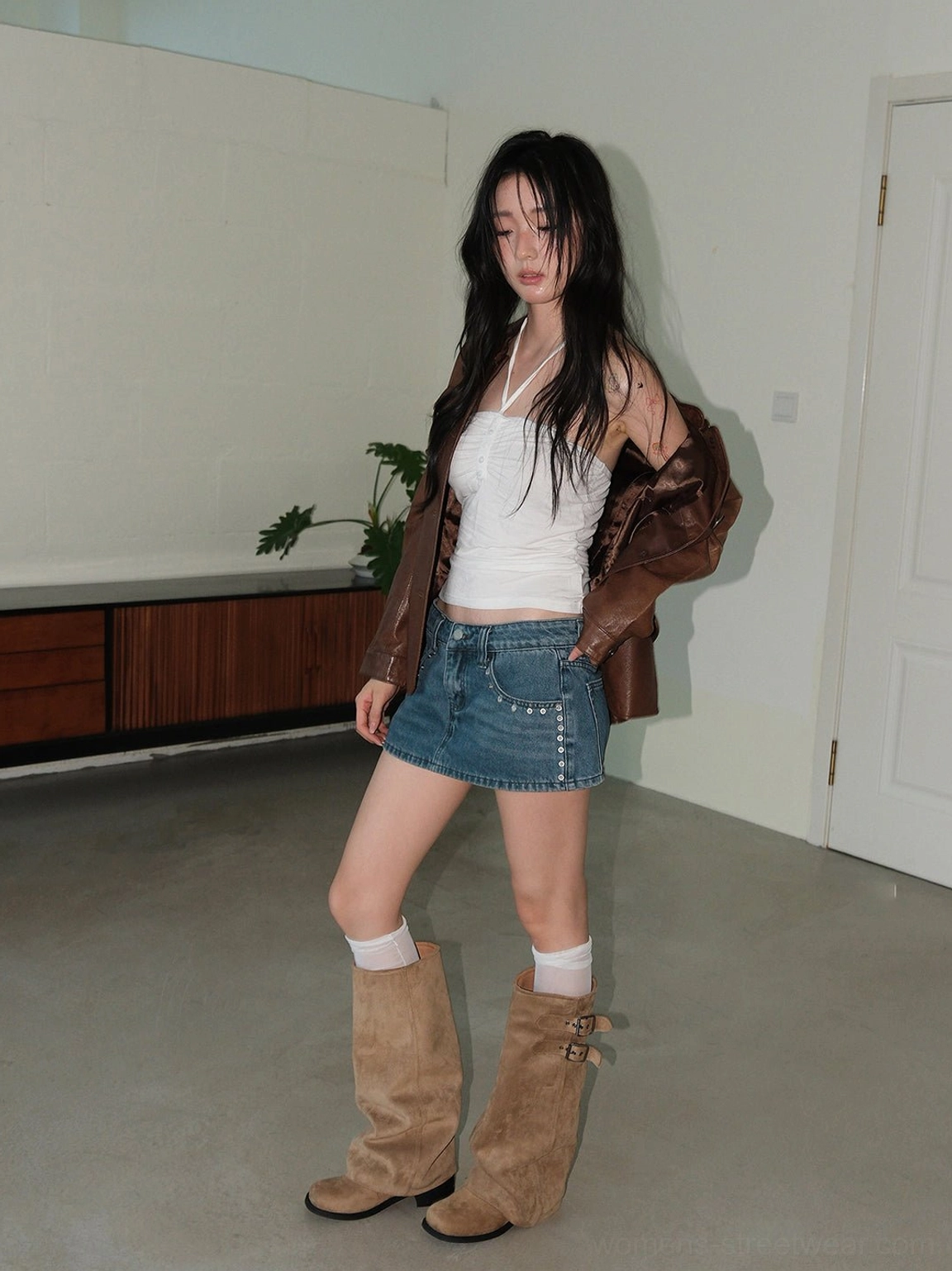 Camel tall slouch riding boots with low block heel styled with mini skirt and leather jacket