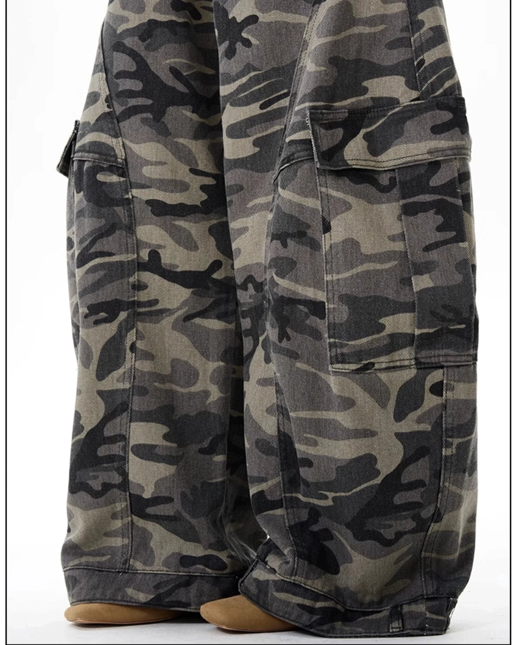 Close-up of women's camo cargo pants showing large flap-covered side pockets, reinforced hems, and woodland camouflage fabric