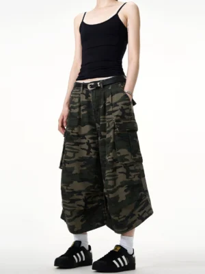Front full-body view of women's camouflage wide-leg cargo culottes with oversized utility pockets and cropped streetwear silhouette