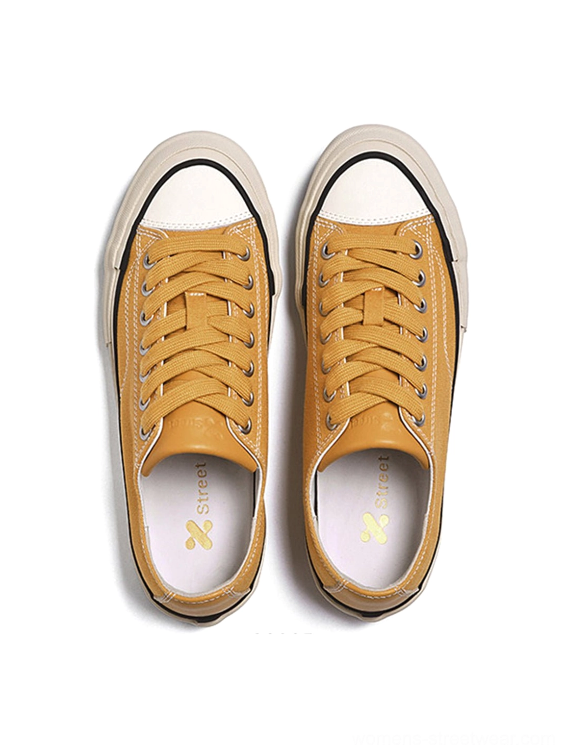 Side profile of canvas low-top platform sneaker with cork midsole, showing minimal profile and accessible silhouette