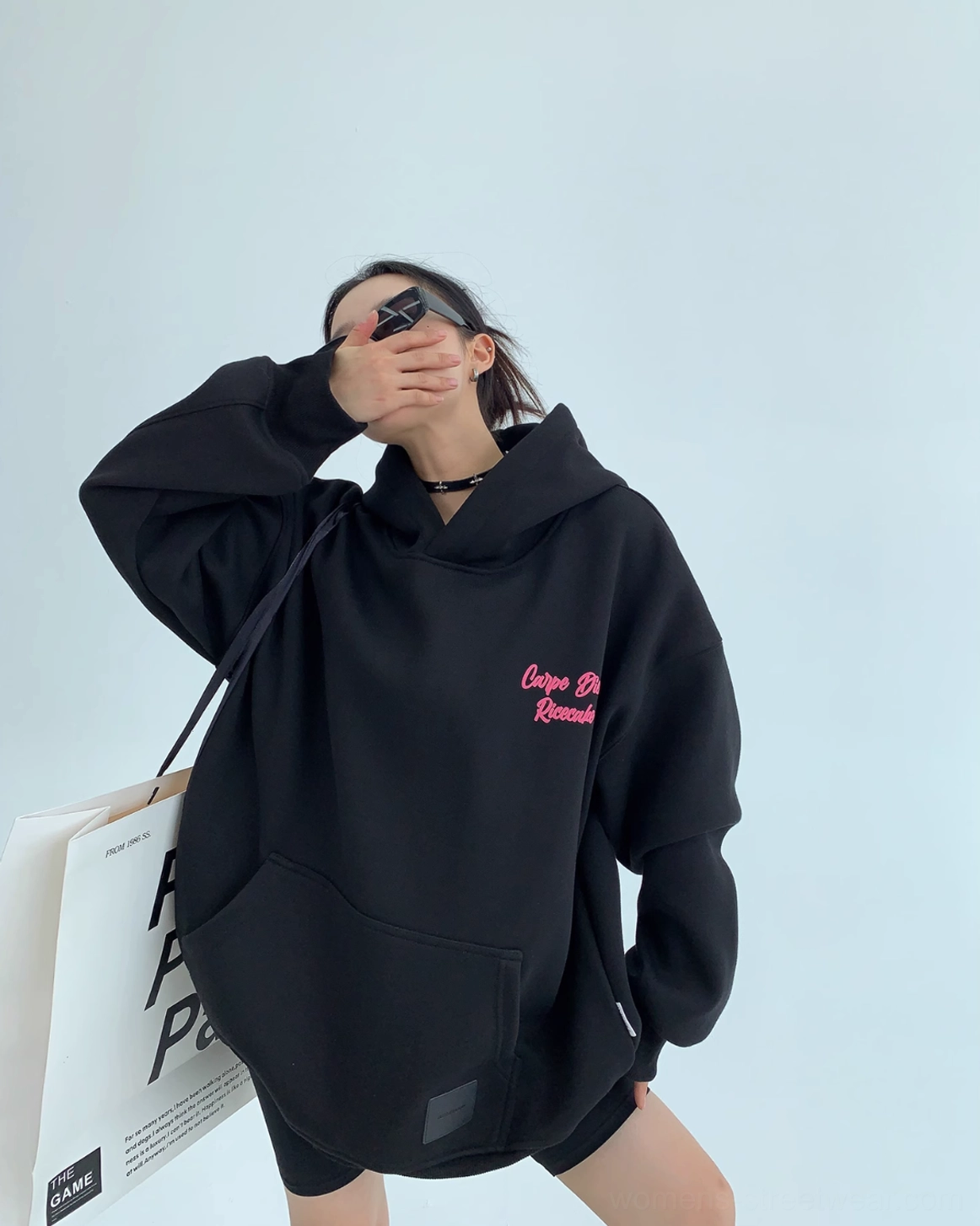 Black oversized Carpe Diem hoodie with hot pink cursive streetwear graphic detail