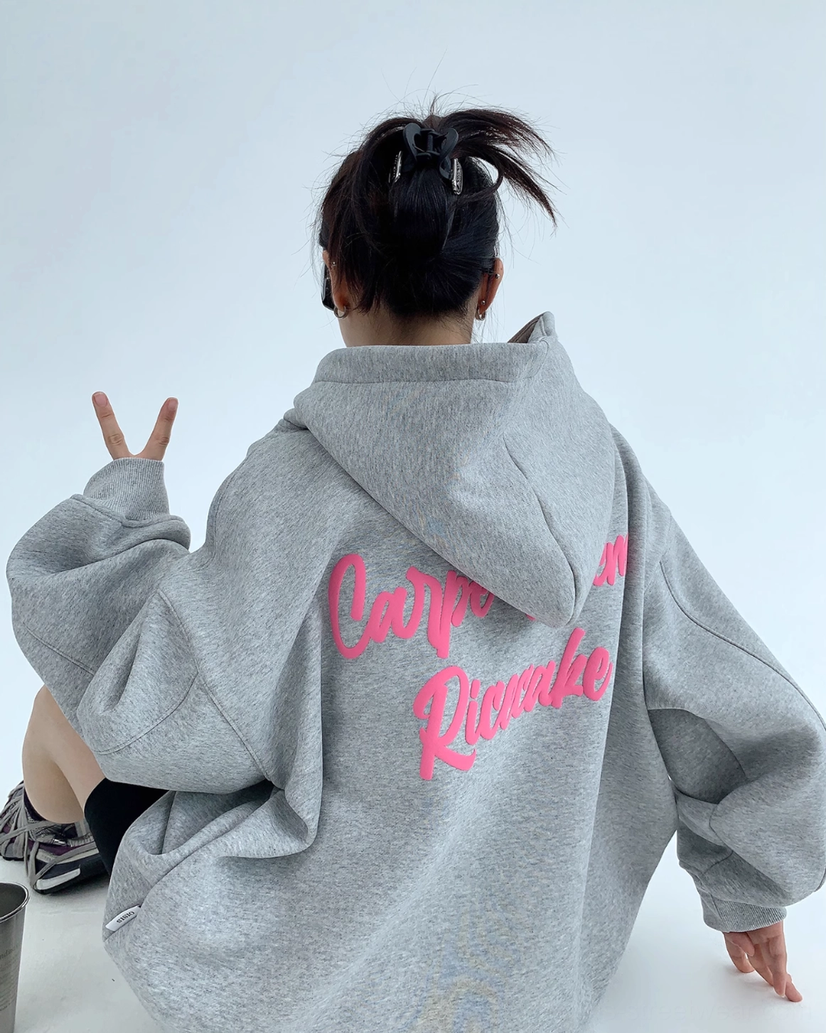 Gray Carpe Diem script graphic oversized hoodie with bright pink back lettering in relaxed streetwear styling