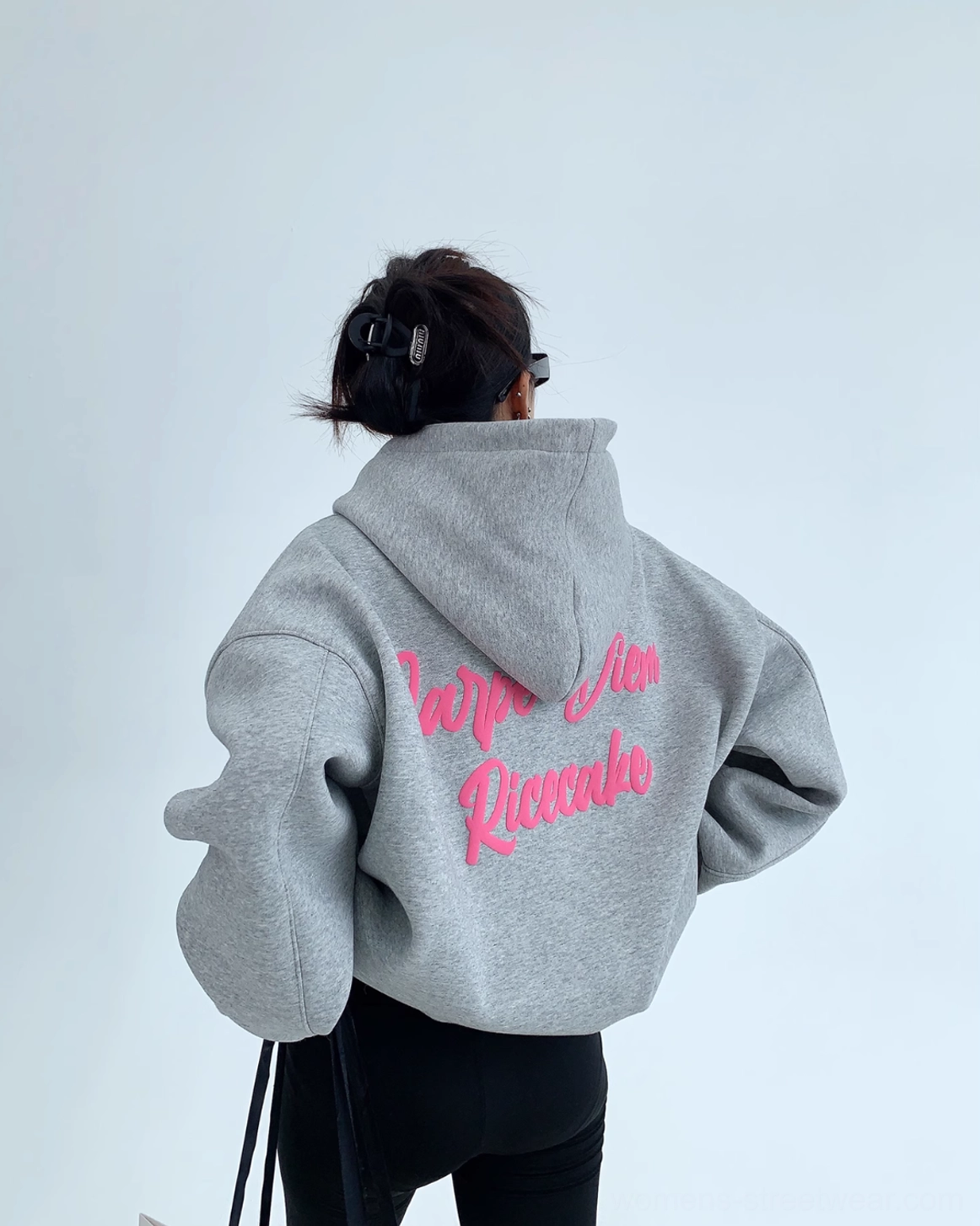 Rear side view of gray oversized Carpe Diem streetwear hoodie with cozy hood and pink script print