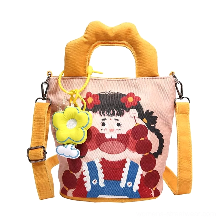 Adjustable shoulder strap detail of cartoon canvas tote showing metal buckle and webbing construction for crossbody carrying option