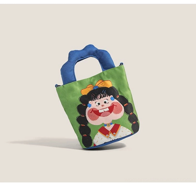 Right-side oblique top perspective of cartoon girl canvas tote displaying playful braided ponytail girl graphic and blue padded handles