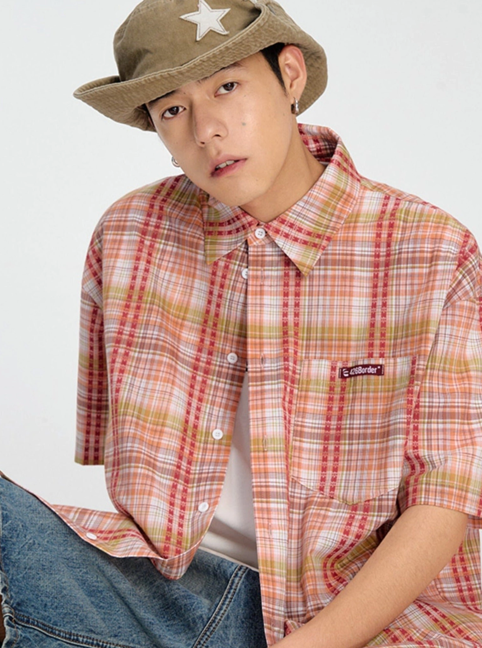 Casual plaid short sleeve shirt image showing the lightweight summer streetwear silhouette and button-front styling