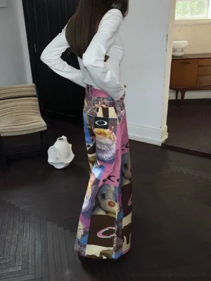 Back three-quarter view of cat birthday cake patchwork high-waist wide-leg streetwear pants styled with a fitted white top