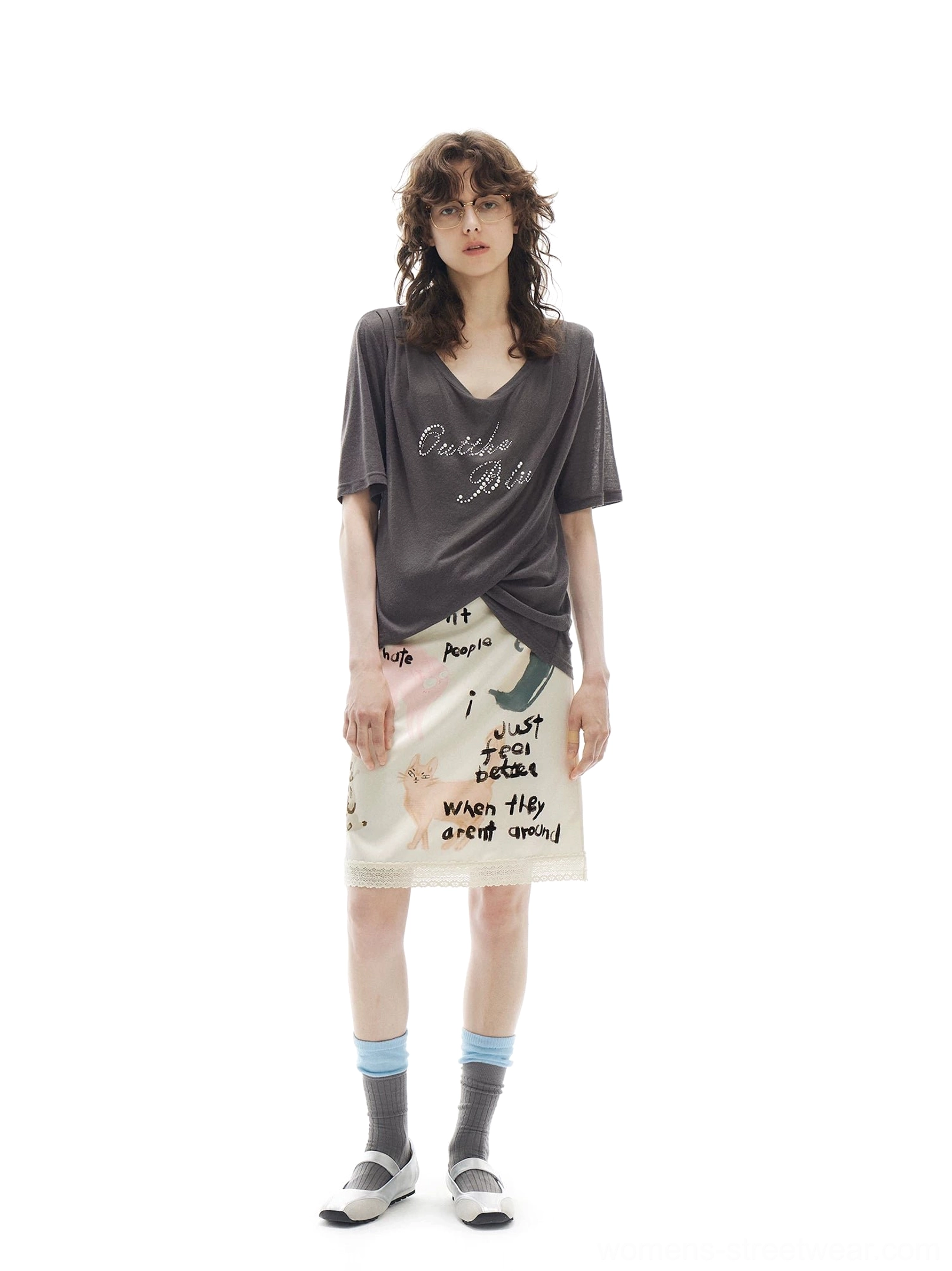 Apricot cream cat graffiti pencil skirt styled with a loose charcoal V-neck tee and white loafers in a casual urban outfit