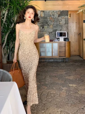 Champagne apricot sequin fishtail evening gown with V neck spaghetti straps and floor length bodycon silhouette