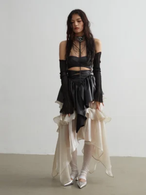 Champagne goldfish ruffle skirt styled with a black faux leather bandeau top, asymmetrical peplum waist, long gloves, and silver pointed heels