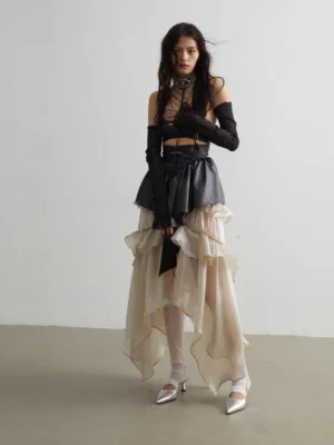 Champagne organza goldfish ruffle skirt outfit with a black peplum waist, sheer white stockings, and silver shoes