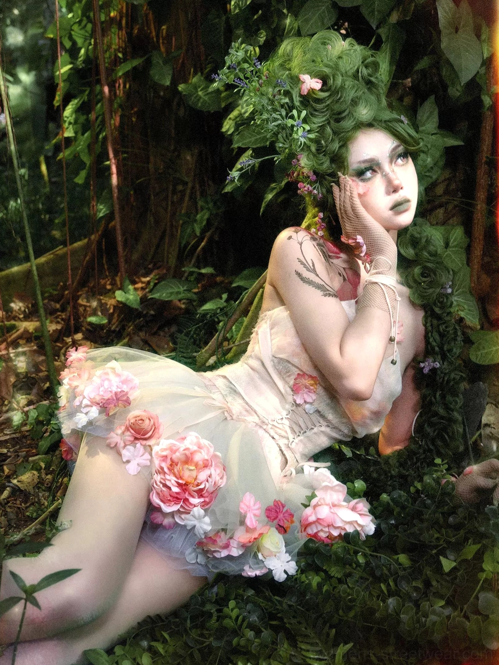Layered champagne pink floral tulle petticoat with pink and peach flower appliques shown in a reclining fairycore outfit
