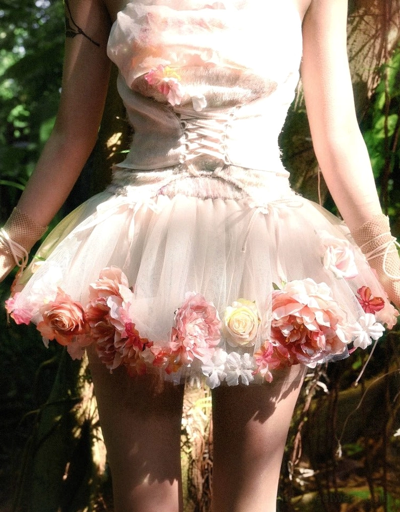 Rear close-up of layered champagne pink floral tulle petticoat with wide hem and mixed pink peach rose appliques