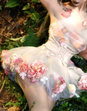 Side close-up of champagne pink floral tulle petticoat with dimensional rose appliques styled under a fairycore corset outfit in a tropical forest