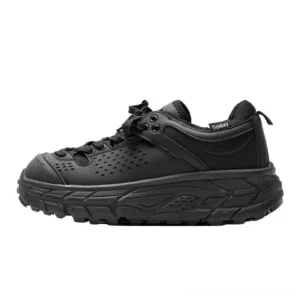 Charcoal black chunky trail sneakers shown in a front side studio profile with rugged perforated upper, rounded toe guard and heavy-duty traction outsole