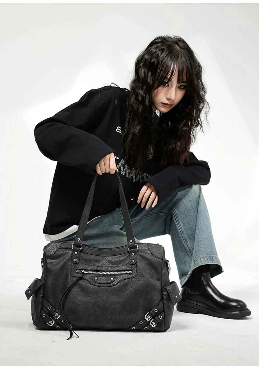 Charcoal buckle rider tote bag front detail with large structured capacity decorative buckles studs and silver hardware