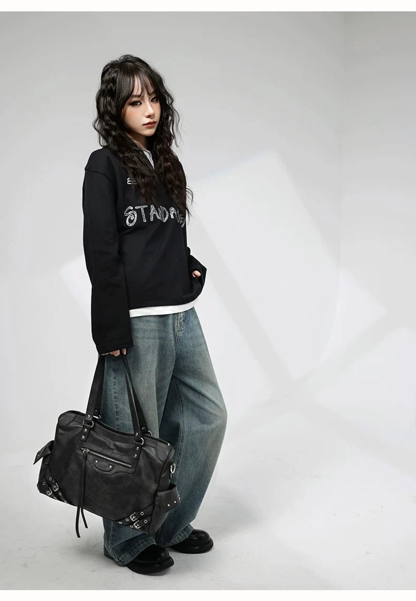 Charcoal buckle rider tote bag side view showing structured distressed faux leather silhouette and silver hardware