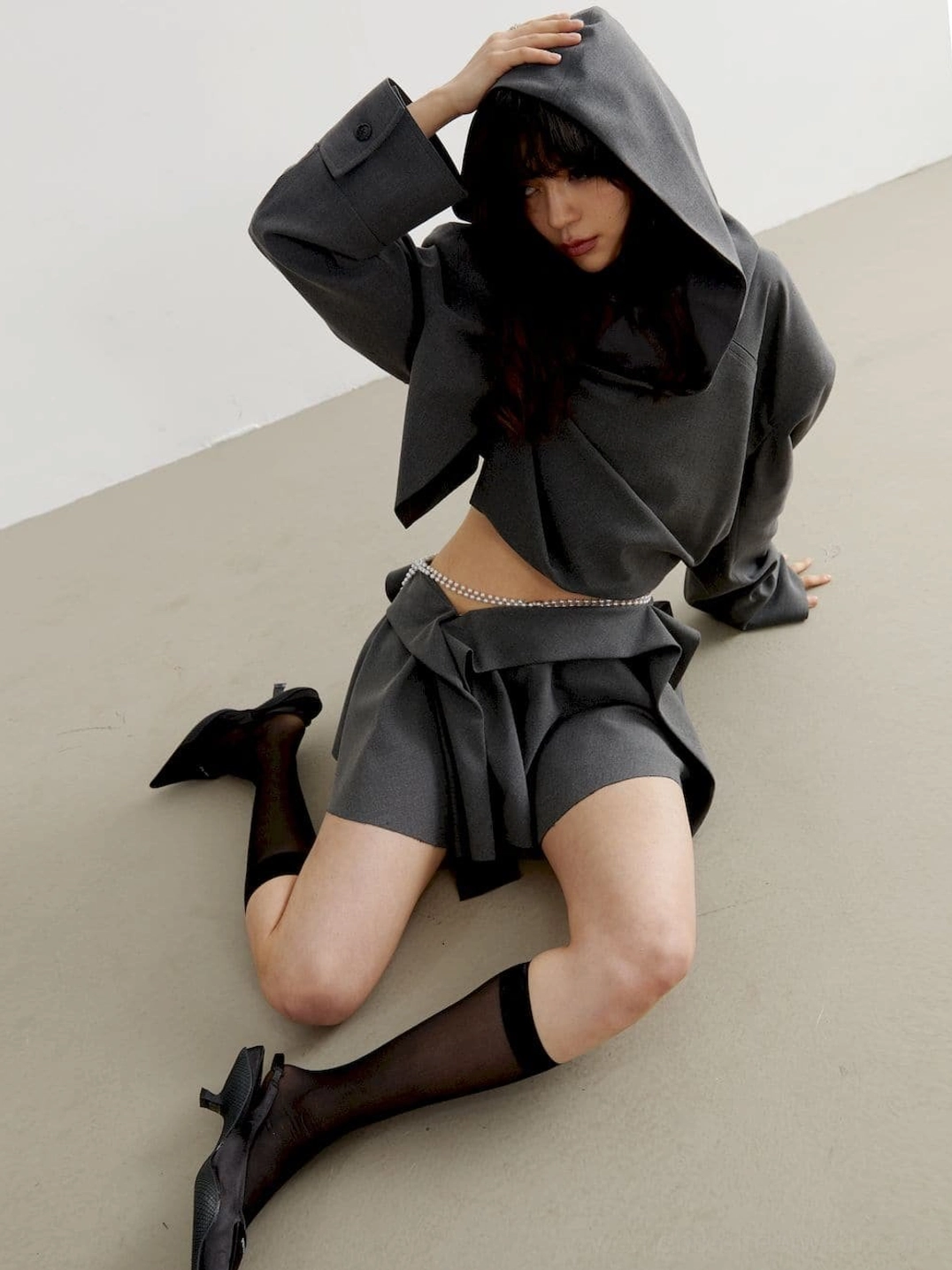 Charcoal cropped oversized hoodie styled with sheer black stockings and pointed toe heels for a Korean Y2K fashion look