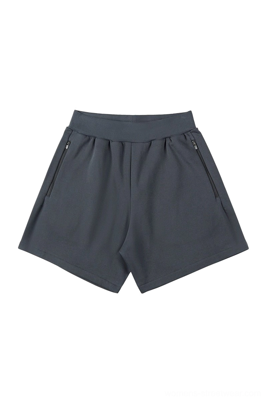 Charcoal dark gray relaxed streetwear shorts with soft knit texture elastic waistband and two angled zipper pockets