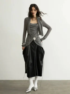 Charcoal gray asymmetric layered long sleeve top styled with a black leather midi skirt and silver heels in a modern Korean streetwear outfit
