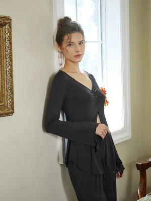 Side view of charcoal gray vintage loungewear set with fitted button-up top, ruffled hem detail, and relaxed wide-leg trousers
