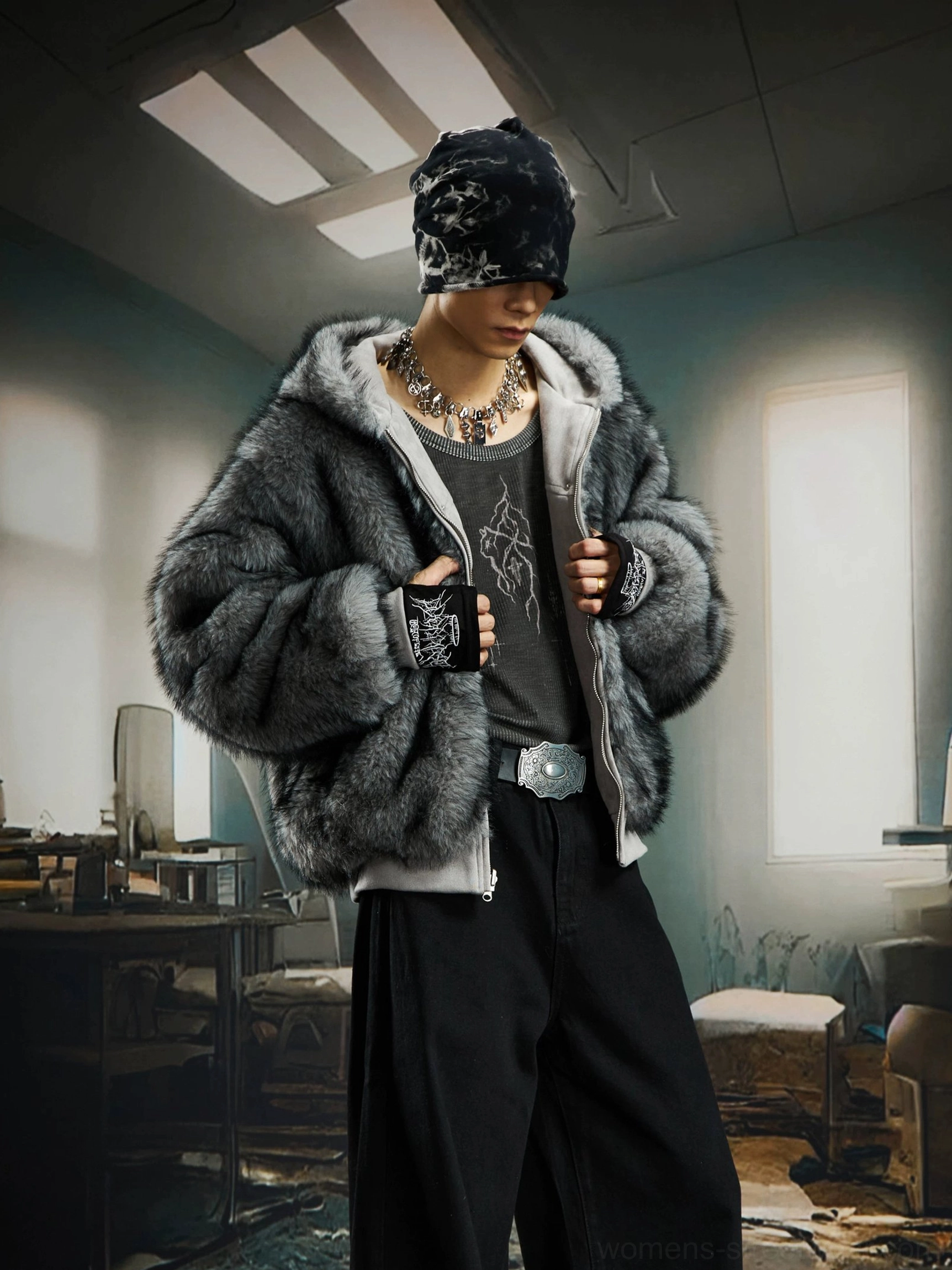 Male model wearing the charcoal gray faux fur side of a reversible hooded bomber jacket with relaxed streetwear styling