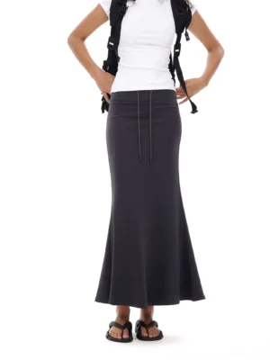 Dark charcoal gray fitted mermaid maxi skirt shown from a low back three-quarter view with an adjustable drawstring waist and floor-length fishtail hem