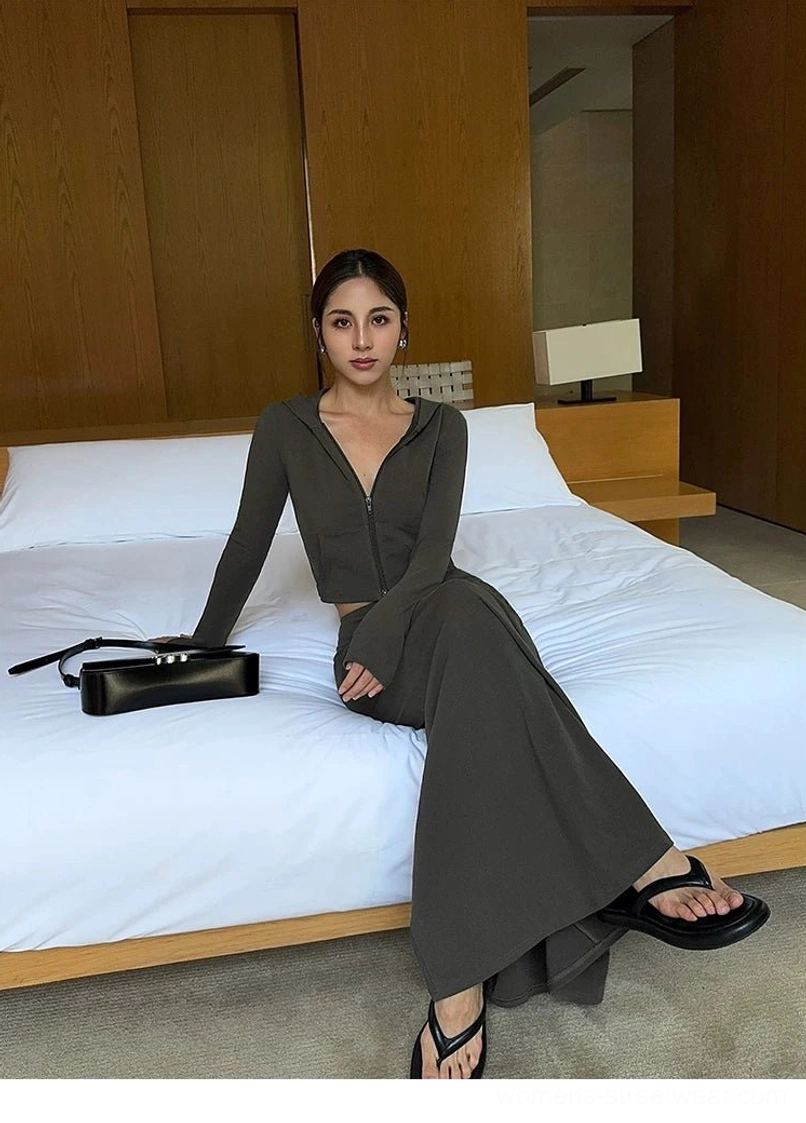 Charcoal gray jersey maxi skirt styled as a matching two-piece outfit with a cropped zip-up top