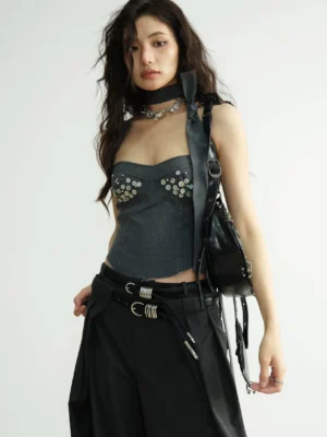 Charcoal gray sequin studded corset bustier top styled with wide-leg trousers and a statement belt in a minimalist studio