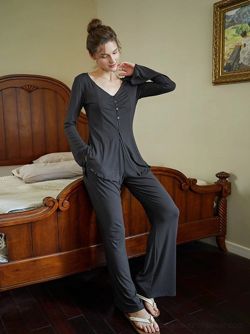Charcoal gray slim-fit long-sleeve button-down top paired with high-waisted wide-leg pants and casual slide sandals