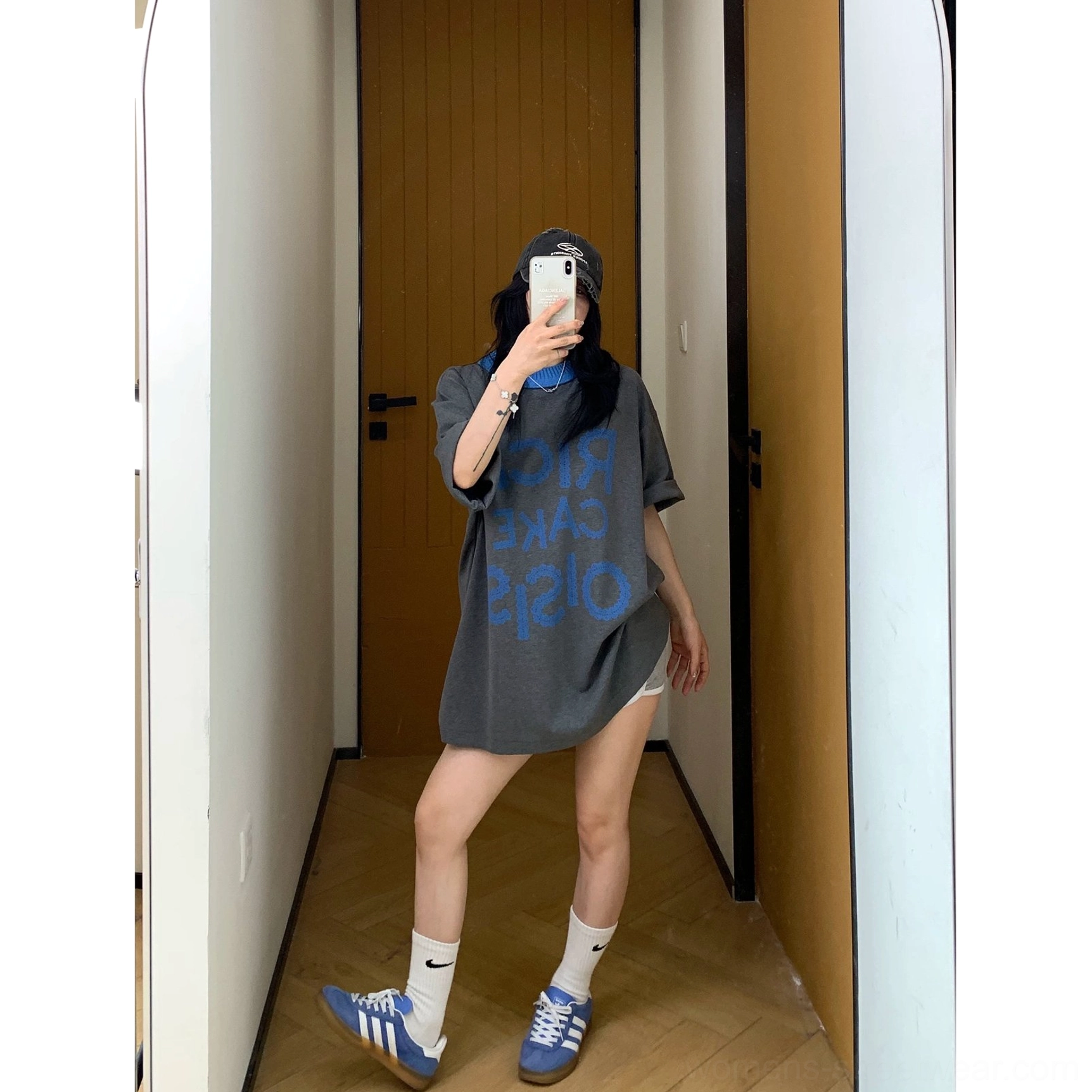 Back view of a charcoal oversized solid short-sleeve T-shirt showing the clean plain back, relaxed hemline, and loose streetwear fit