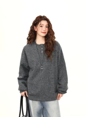 Front view of charcoal gray pinstripe oversized Henley knit pullover with button neckline and relaxed drop shoulder sleeves