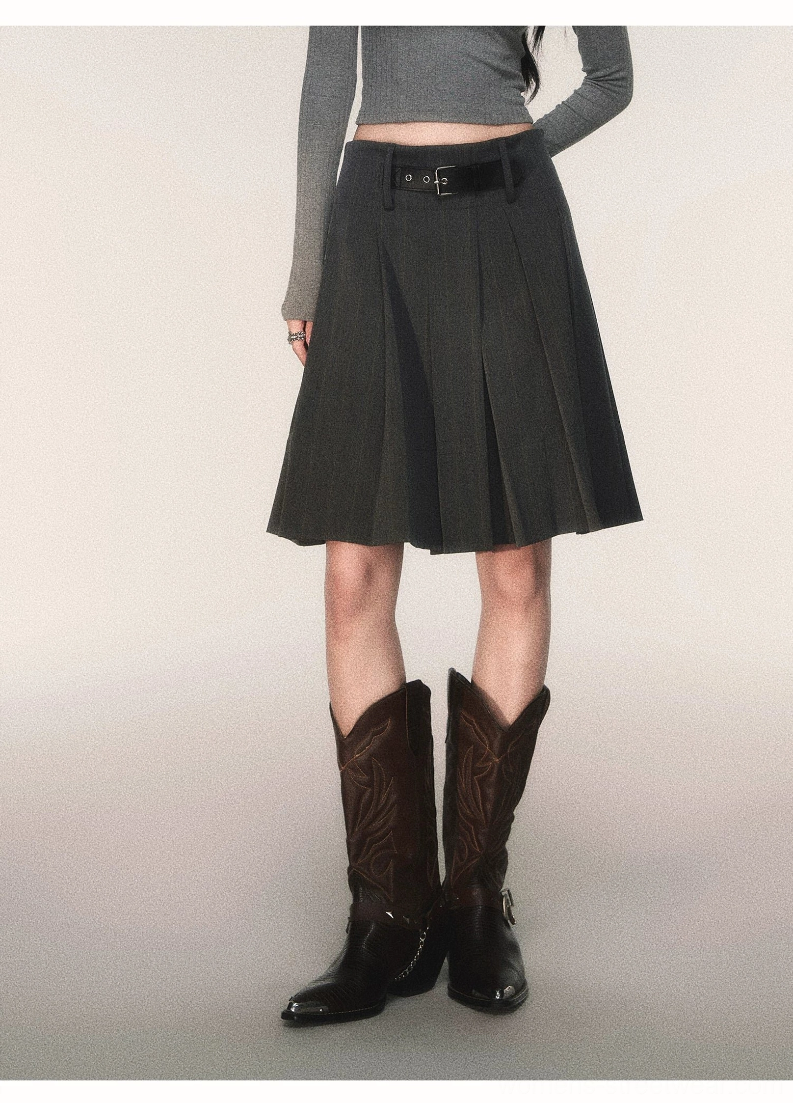 High waisted charcoal pinstripe pleated midi skirt with black buckle belt and tailored A-line silhouette front detail