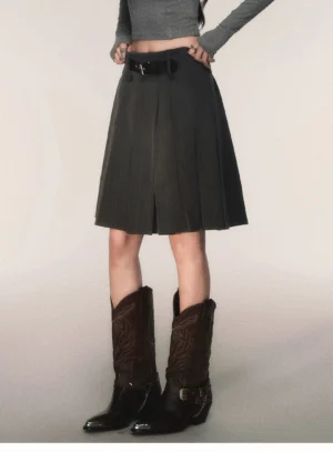 Charcoal gray pinstripe pleated midi skirt with detachable black belt styled with cropped gray top and brown cowboy boots front view
