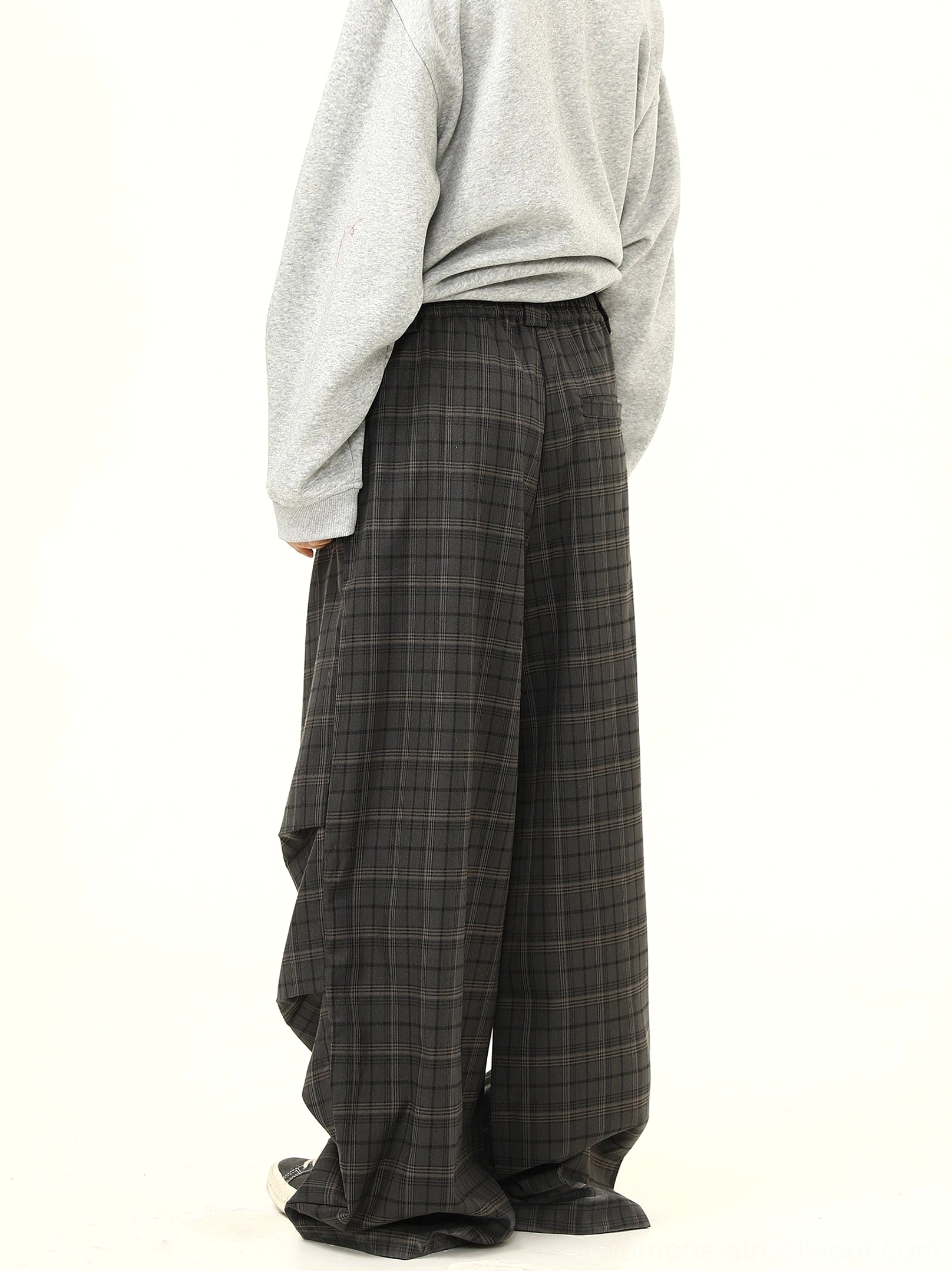 Right rear view of charcoal plaid wide-leg pants showing elastic back waistband flowing pleats and relaxed Korean fashion silhouette