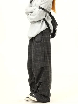 Side view of relaxed charcoal plaid wide-leg pants with elastic waistband draped pleats and oversized Korean streetwear styling