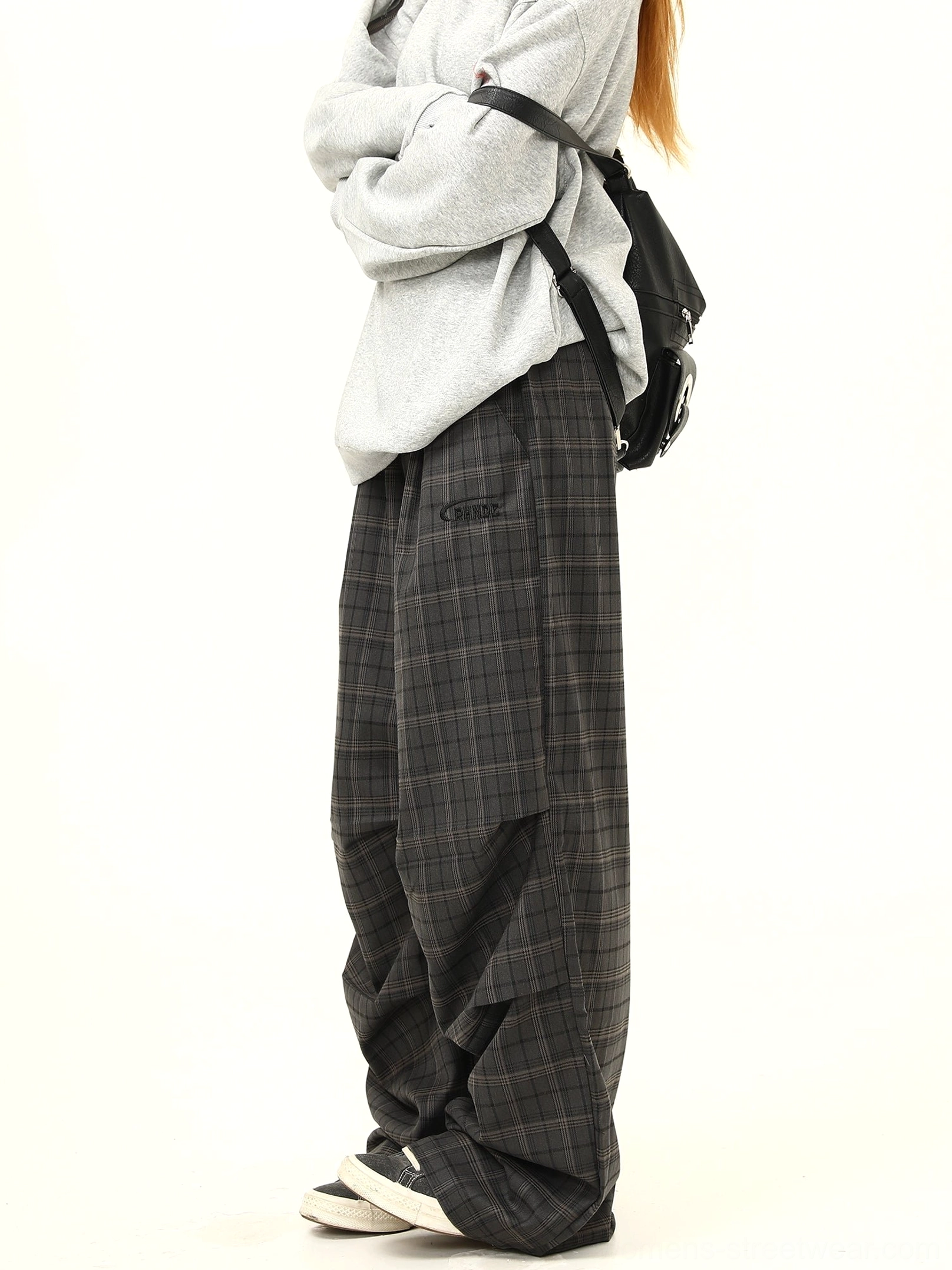 Side view of relaxed charcoal plaid wide-leg pants with elastic waistband draped pleats and oversized Korean streetwear styling