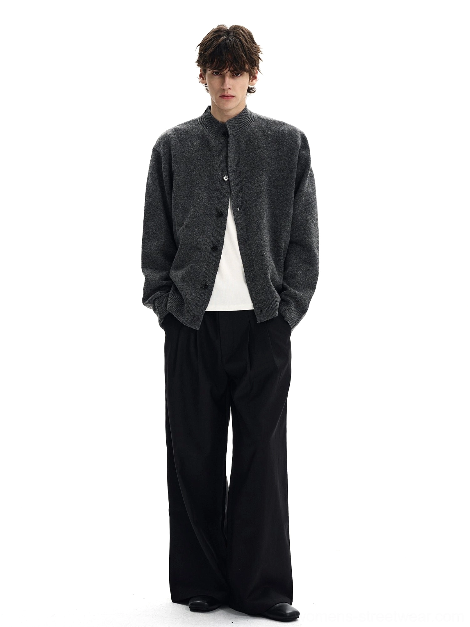 Full length view of charcoal relaxed fit stand collar knit cardigan styled with dark wide leg trousers