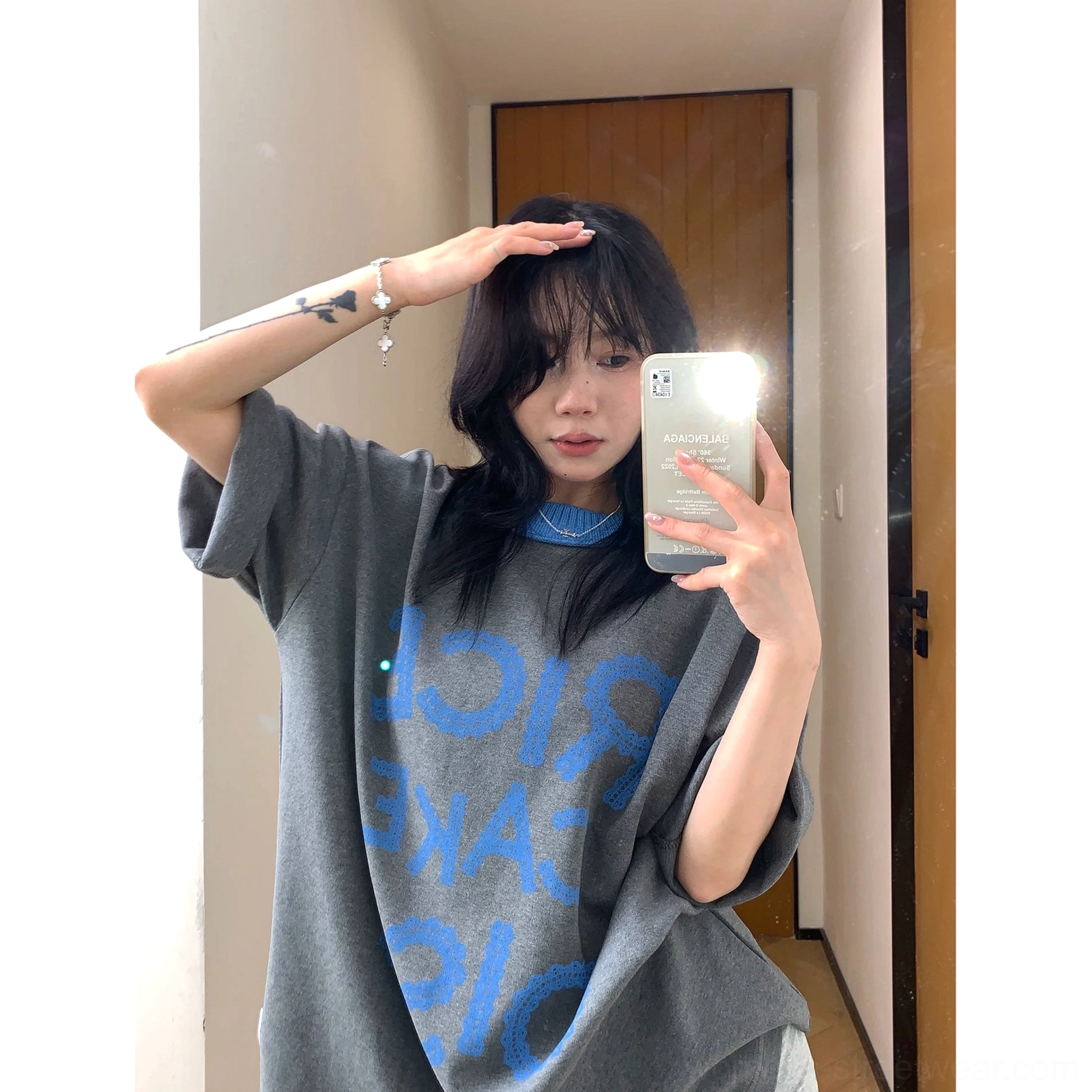 Close-up view of charcoal oversized T-shirt featuring the reversed blue RICE CAKE 015 graphic, soft fabric, and contrast blue ribbed crew neck