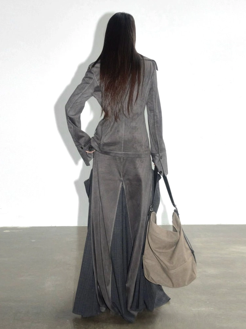 Back three-quarter view of charcoal suede and plaid panel maxi skirt showing the long silhouette and rear hem detail