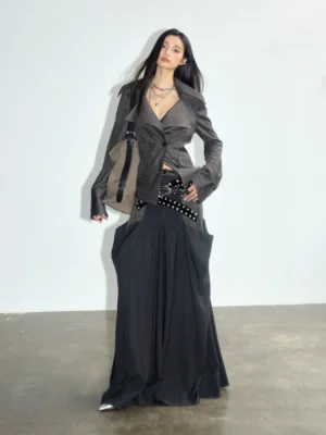 Charcoal suede and plaid panel maxi skirt styled with matching blazer, studded belt and crossbody bag in a front three-quarter studio look