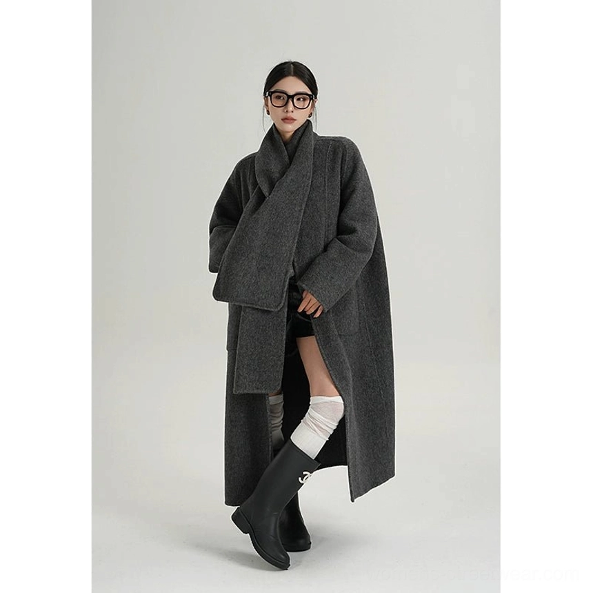 Right three-quarter view of a charcoal grey oversized wool coat featuring an integrated wide wrap scarf collar and avant-garde cocoon shape