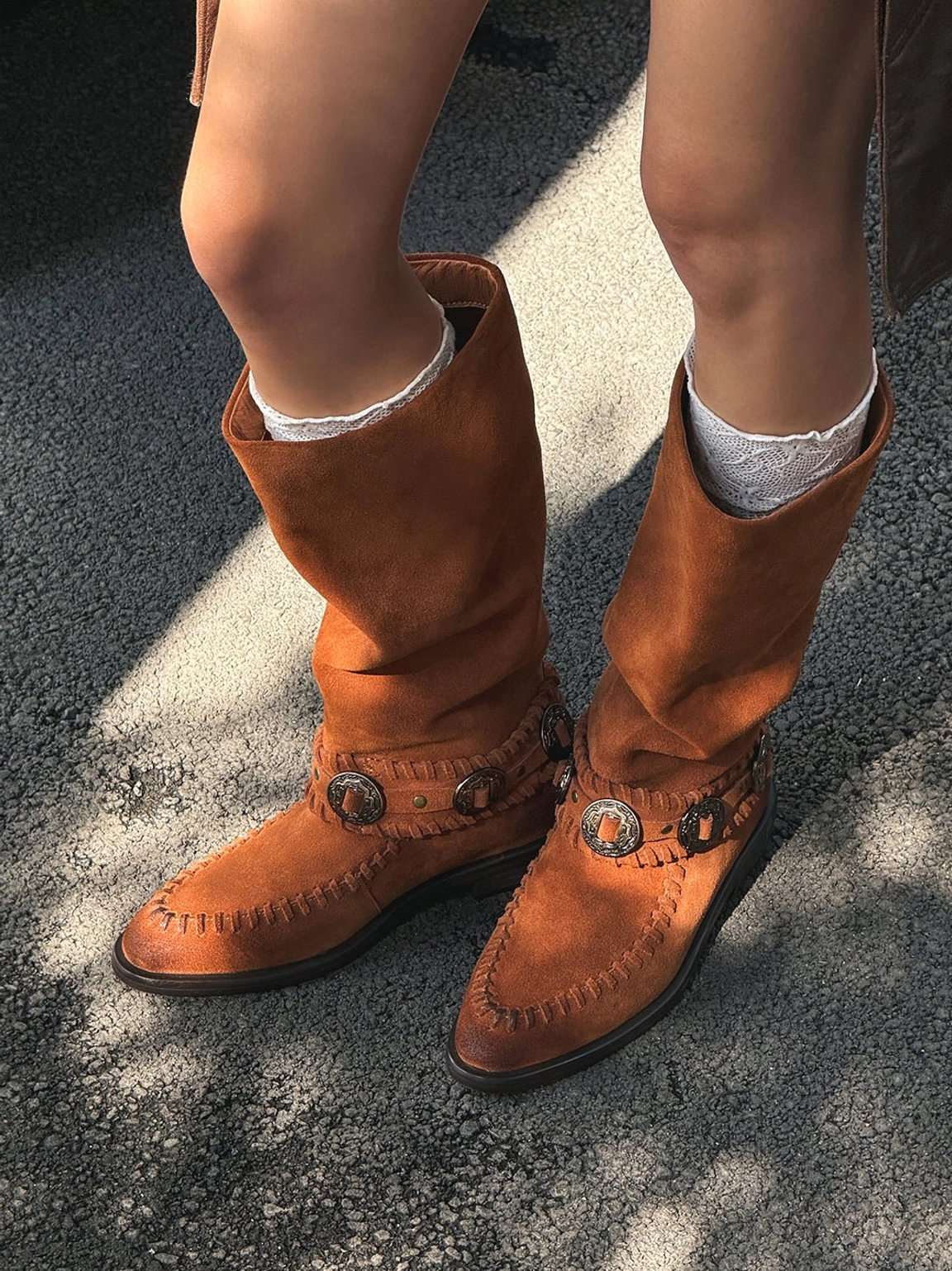 Chestnut brown suede western riding boots styled with white frilly ankle socks, slouchy knee-high shafts, and decorative buckles